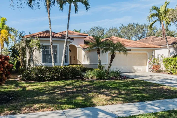 Mediterranean / spanish-style home with a garage and a front yard