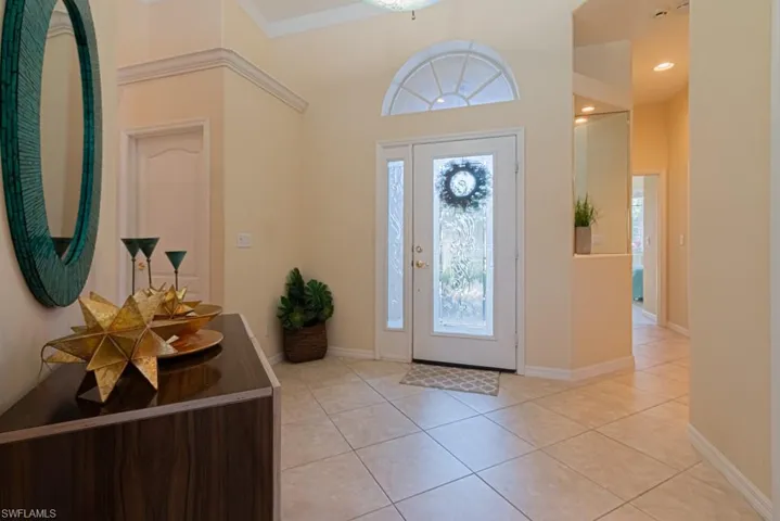 Foyer entrance with light tile patterned flooring