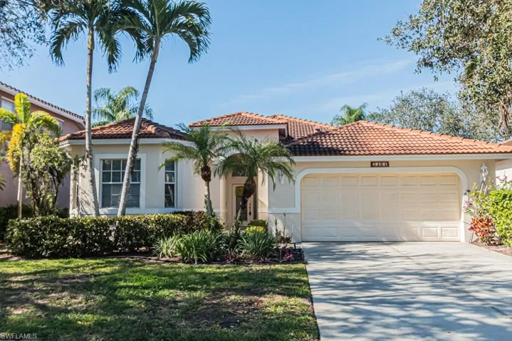 Mediterranean / spanish house featuring a garage and a front yard