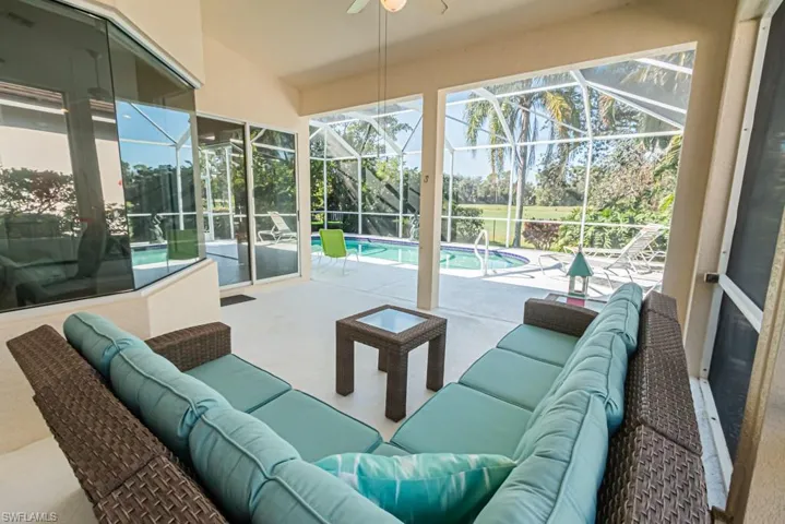 Sunroom / solarium featuring a swimming pool, lofted ceiling, and ceiling fan