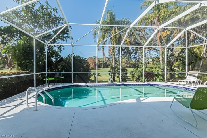 View of swimming pool featuring a lanai and a patio