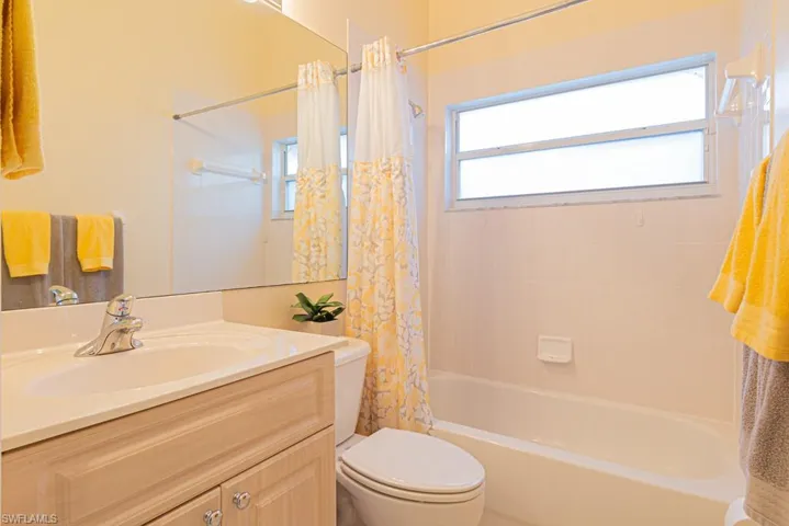 Full bathroom with vanity, toilet, and shower / bath combo