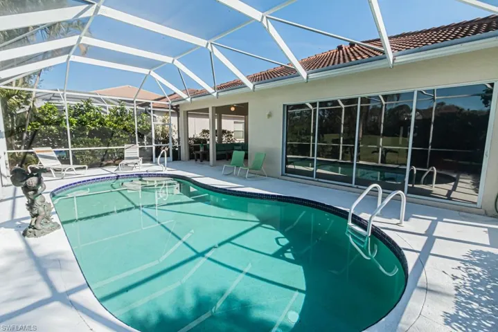 View of swimming pool with a lanai and a patio
