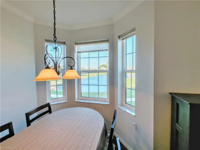 Dining room featuring plenty of natural light and crown molding