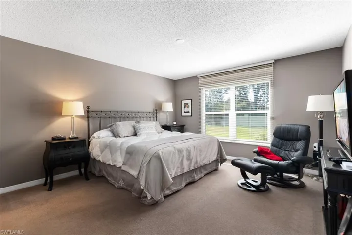 Bedroom with carpet floors and a textured ceiling
