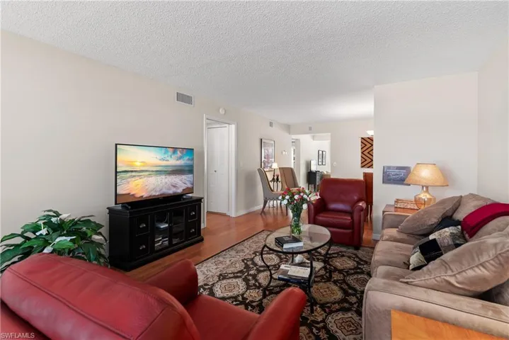 Living room featuring wood finished floors and a textured ceiling