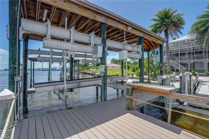 Dock with boat lift and a water view - Virtually Edited Image
