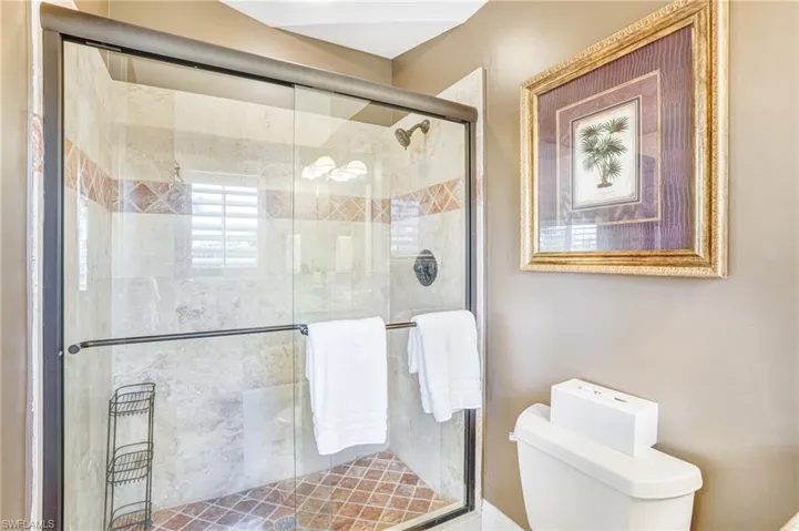 Bathroom with toilet and a stall shower - Virtually Edited Image