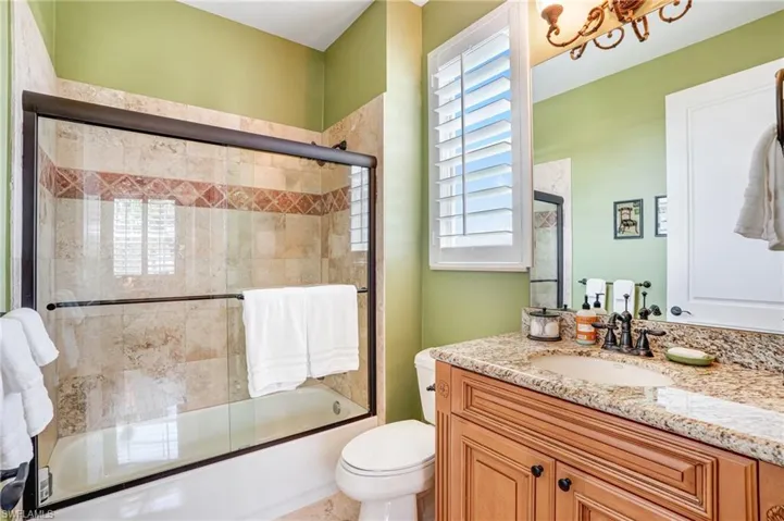 Bathroom with enclosed tub / shower combo and vanity - Virtually Edited Image