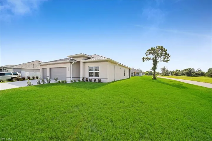 Ranch-style house with a front yard and a garage