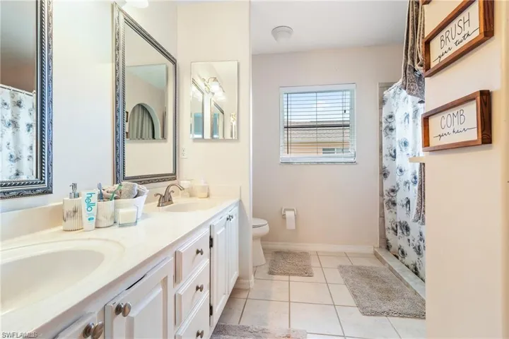 Main bath with double sinks, large updated shower and walk-in closet