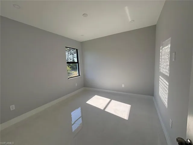 Empty room with tile patterned floors and baseboards