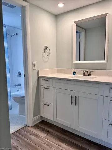Full bathroom featuring tiled shower / bath, tile flooring, toilet, and vanity
