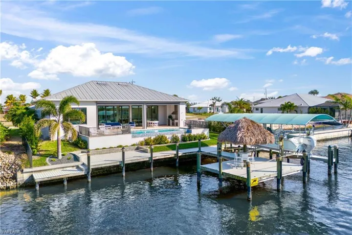 Daytime view of the back yard and dock - there is an easy launch pad for kayaking or paddle boarding - be sure to check out the Great Calusa Blueway - over 190 miles of marked trails for kayakers and paddle boarders!  Easy access from the home and a twenty plus year Lee County tradition.