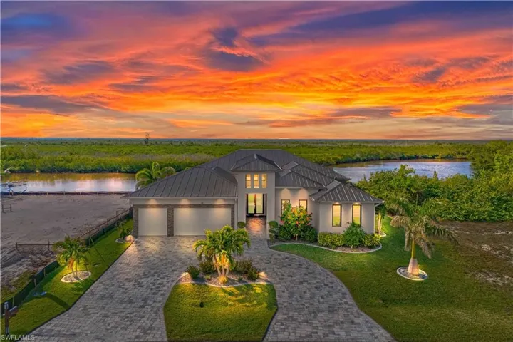 Stunning custom warm contemporary home - beautiful lush landscaping, pavered circular driveway, curbing and night lighting!