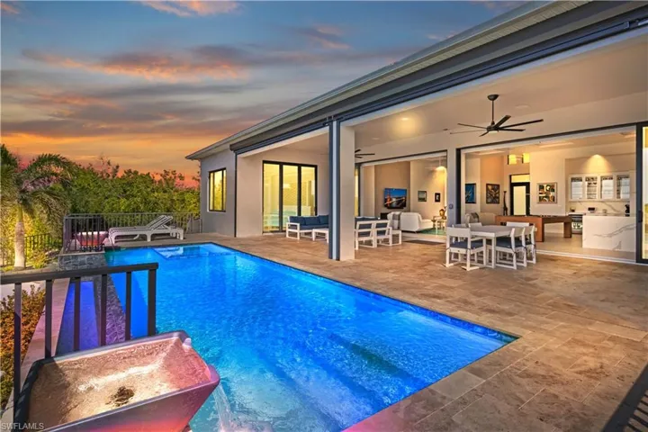 Twilight view of the pool and the back patio area!