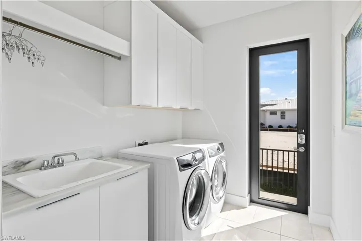 Laundry room with sink and access out to the yard!  Sensible and usable!