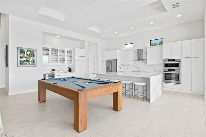 The kitchen is designed with pure entertainment and functionality!  All Bosch appliances, pull out cabinetry, lighted counters and plenty of storage!