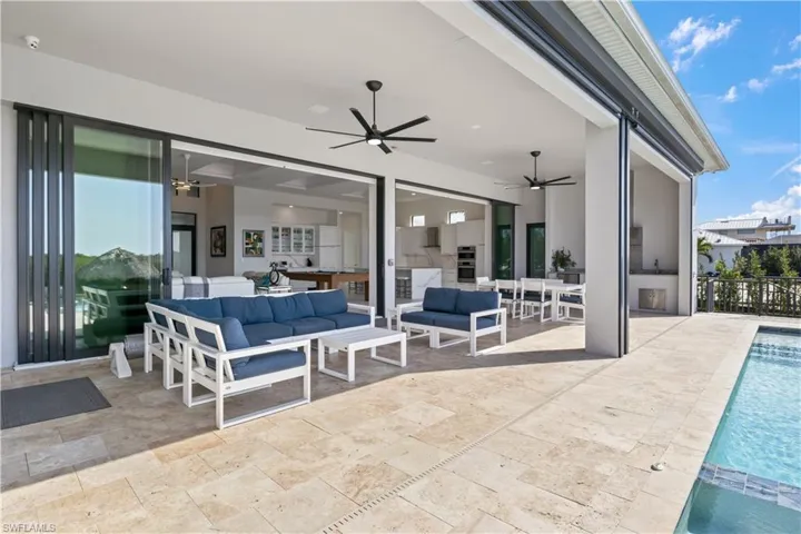 Looking into the home from the pool area - a wall of windows and a very large outdoor covered patio!