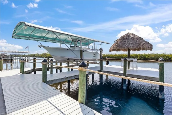 A boater's dream with canopied boatlift, tiki bar, stunning nighttime lighting and quick and easy access to everything!  Deep water for easy launching and THOSE VIEWS!!!!!!!!!