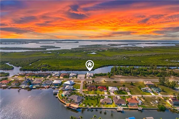 Welcome home to this beautiful waterfront property located directly on the Spreader.  This is an actual sunset sky photo taken from the home.  Located across from the preserve and wide open views and deep water!