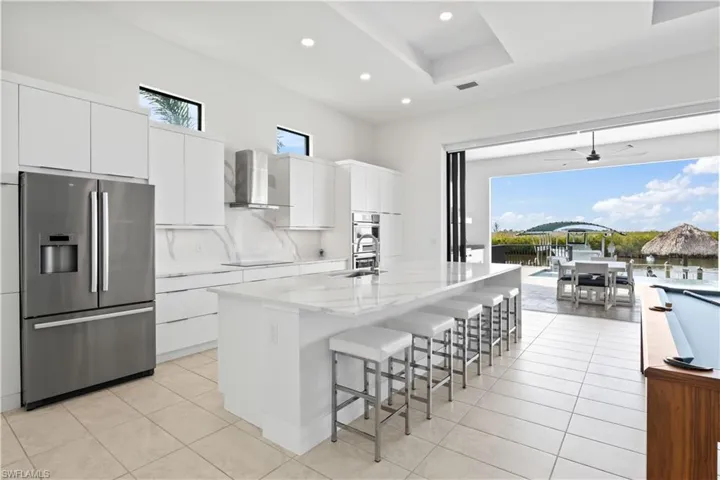 Kitchen island and backsplash are quartz and compliment the design aspect of the home in addition to being very usable.