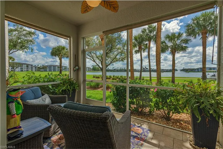 Sunroom featuring a water view, plenty of natural light, and ceiling fan