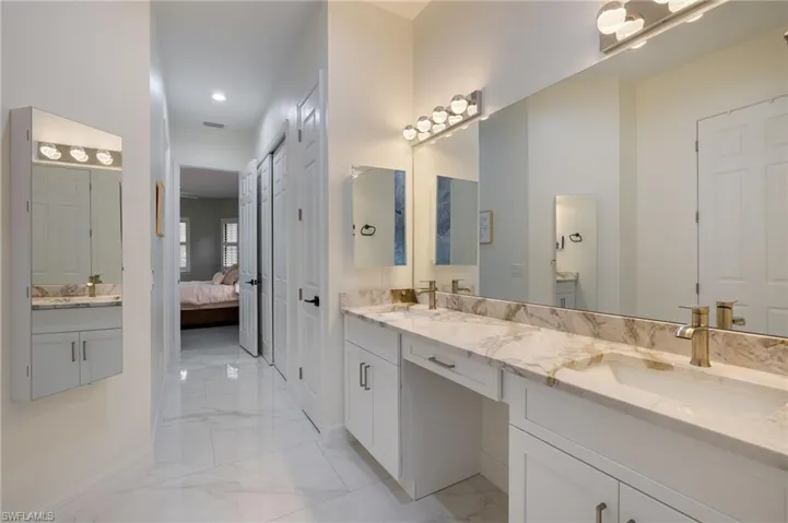 Bedroom with light marble finish floors and a ceiling fan