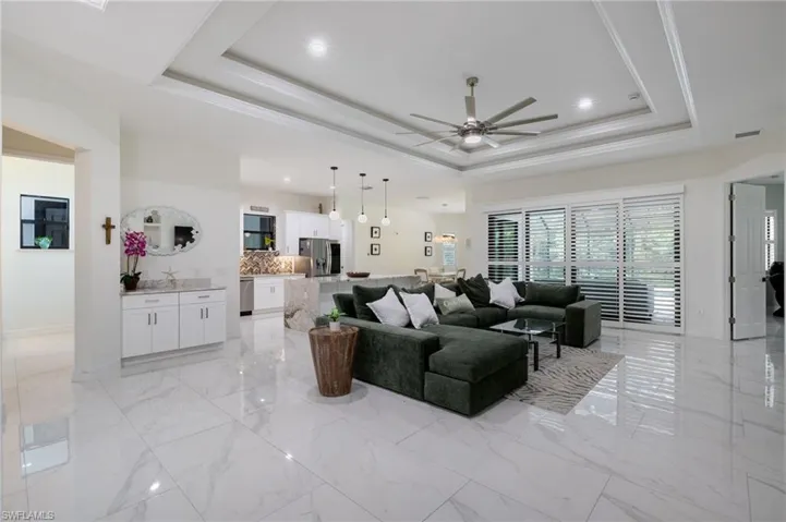 Full bath with light marble finish flooring, ensuite bathroom, and recessed lighting