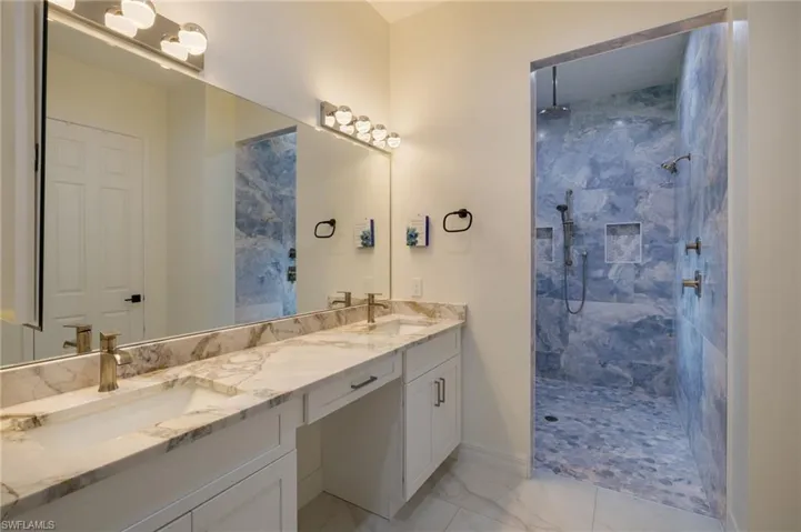 Bedroom featuring marble finish floors and a ceiling fan