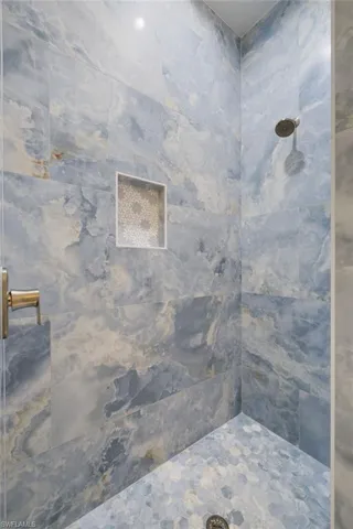 Full bathroom featuring a tile shower