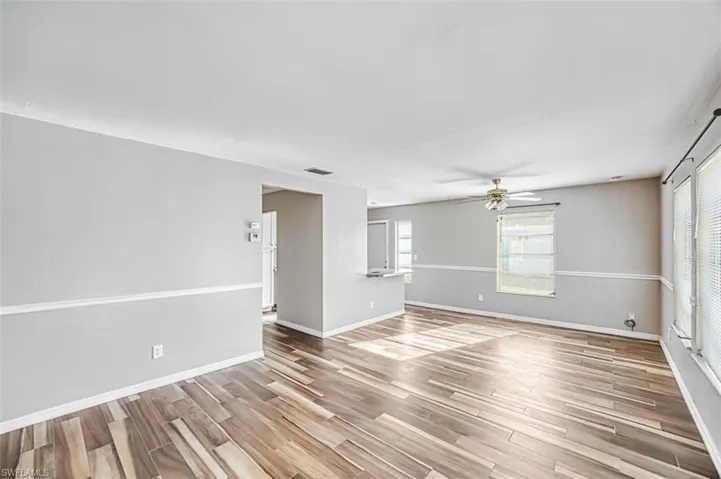 Empty room featuring wood tiled floors and a ceiling fan