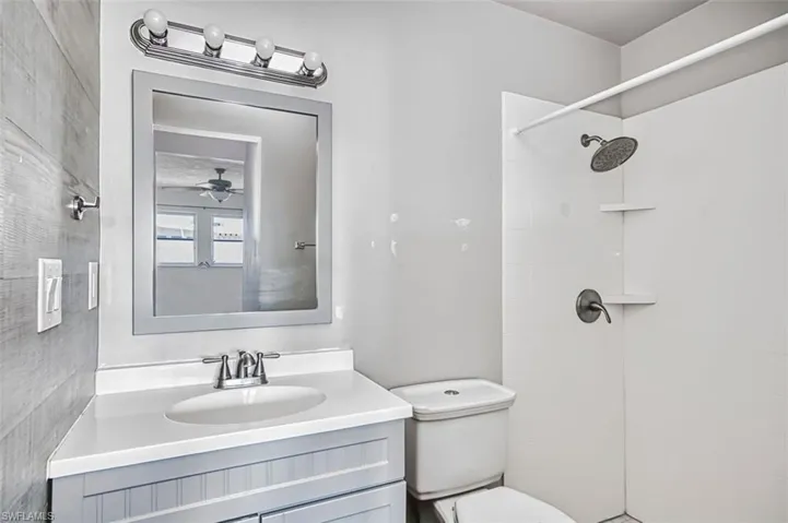 Bathroom featuring vanity and tiled shower