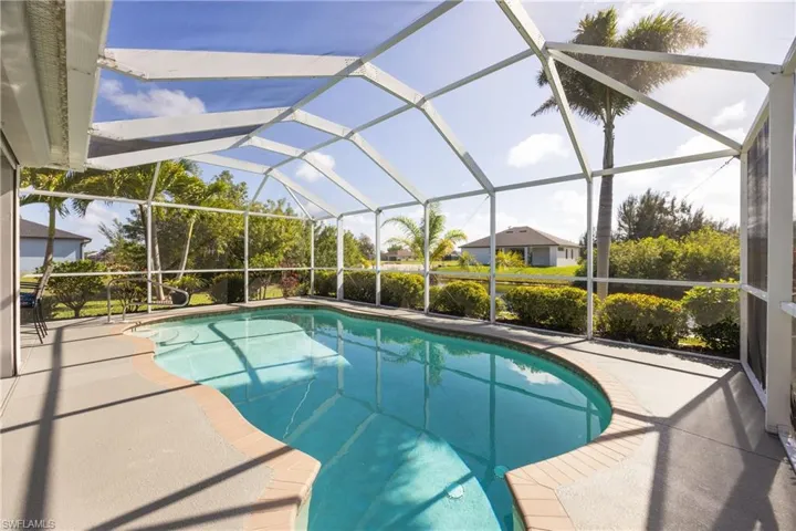Outdoor pool featuring a sunroom, a lanai, and a patio area