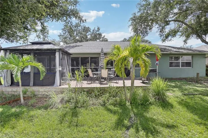 Back of property featuring a patio area and a yard