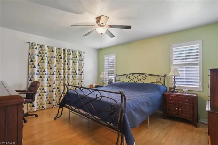 Bedroom with ceiling fan and light hardwood / wood-style flooring