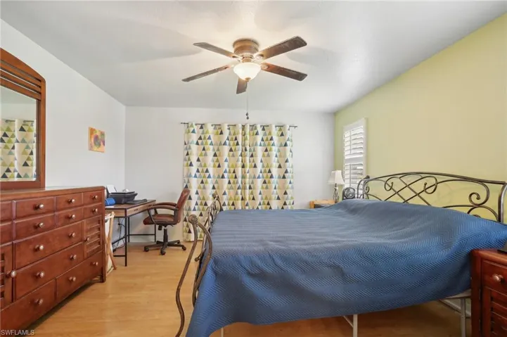 Bedroom featuring ceiling fan and light wood-type flooring