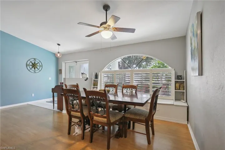 Dining area with ceiling fan and hardwood / wood-style floors