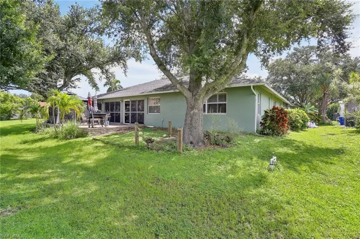 Rear view of property featuring a patio area and a yard