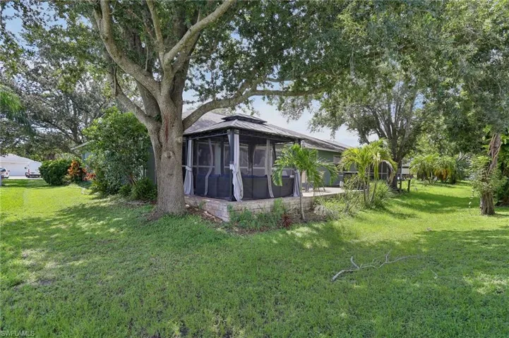 View of yard with a sunroom