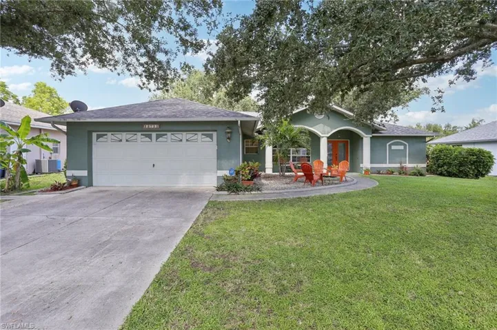 Ranch-style house with a garage, central AC, and a front lawn