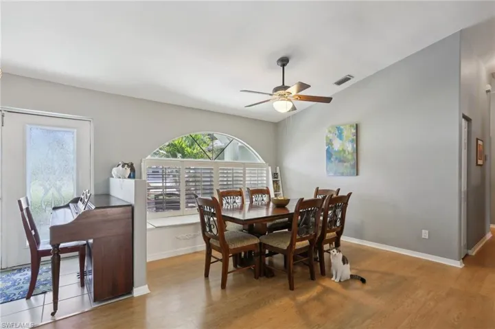 Dining space with light wood-type flooring and ceiling fan