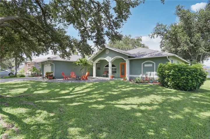 Ranch-style house with a garage and a front lawn