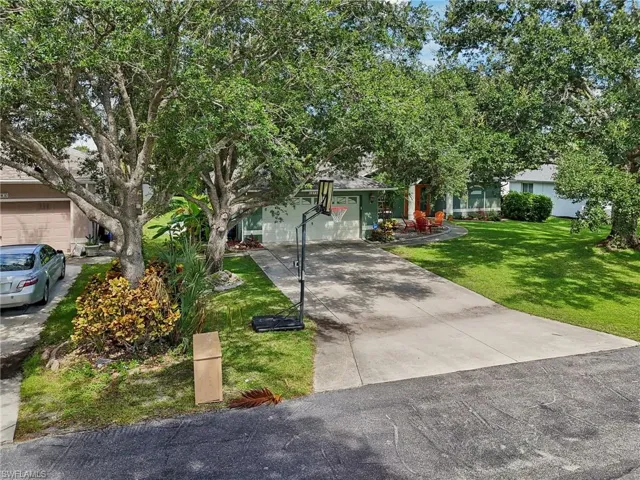 View of front of property with a garage and a front yard