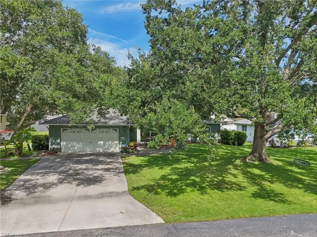 View of front facade with a garage and a front lawn