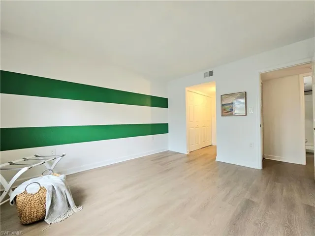 Unfurnished room featuring light wood-type flooring and baseboards