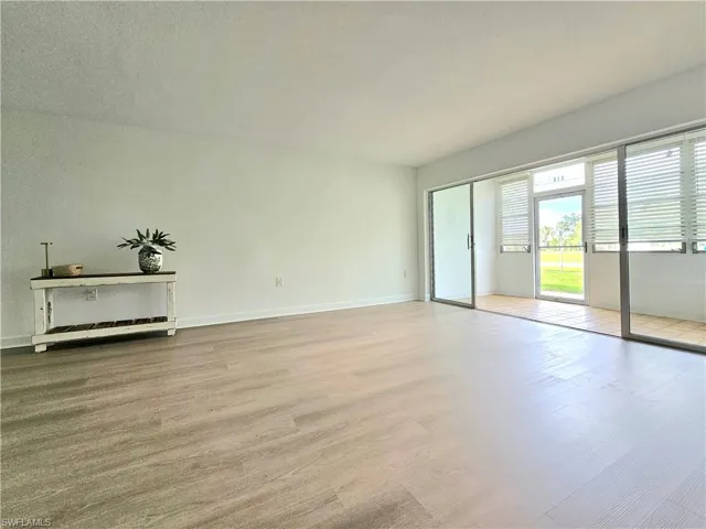 Spare room featuring light wood-style floors and baseboards
