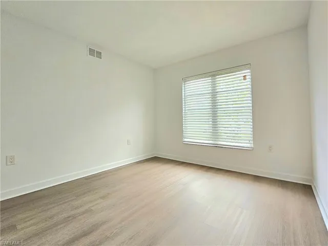 Spare room with light wood-style floors and baseboards