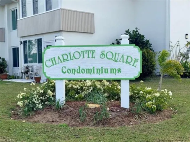 Community / neighborhood sign featuring a lawn