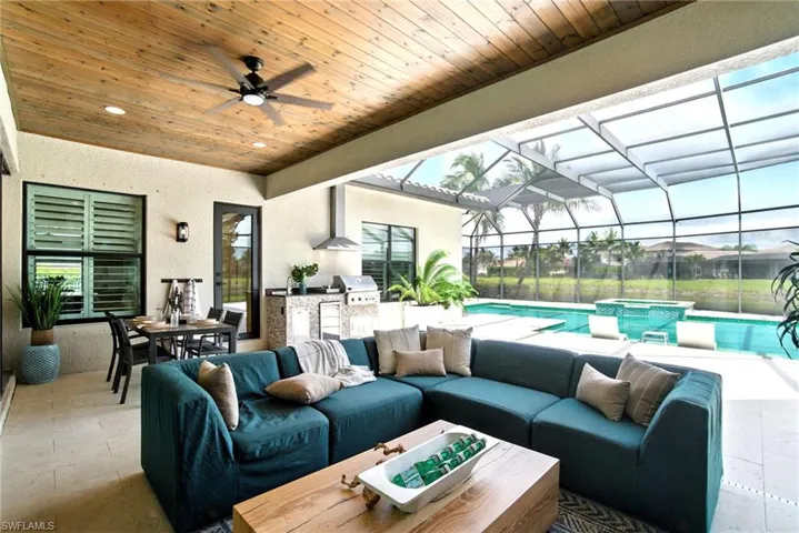 Sunning lakeside views are richly enhanced with wood paneled ceilings under shaded seating and outdoor cooking areas.